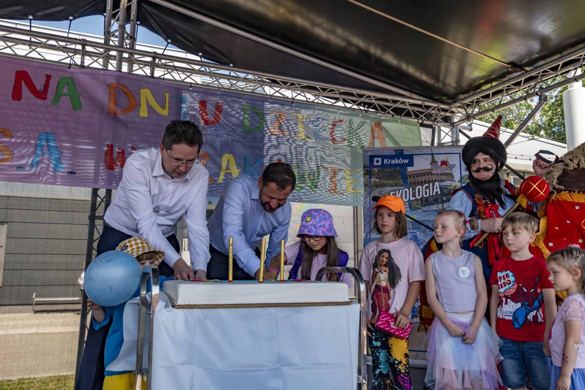 Prezydent Krakowa i prezes zarządu MPK w Krakowie kroją tort dla dzieci
